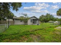 Charming single-story home with a fenced yard and a cozy screened-in porch for relaxing outdoors at 2607 N 59Th St, Tampa, FL 33619
