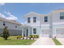 Charming two-story townhome with a well-manicured lawn and a one-car garage at 3062 Victoria Inlet Dr, Holiday, FL 34691