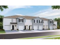 Modern townhome exteriors featuring a neutral color palette, individual garages, and well-maintained landscaping at 32417 Welling Blade Loop, Wesley Chapel, FL 33545