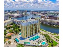 Stunning aerial view of high-rise apartment building along the river with a pool and convenient parking at 345 Bayshore Blvd # 1807, Tampa, FL 33606
