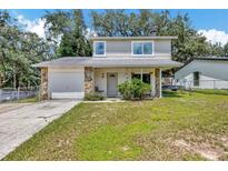 Charming two-story home featuring stone accents, a well-maintained yard, and inviting curb appeal at 4612 E Seneca Ave, Tampa, FL 33617