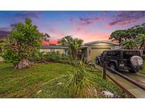 Charming single-story home with a lush green lawn and mature landscaping, offering great curb appeal at 5643 86Th N Ave, Pinellas Park, FL 33782