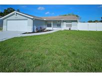 Charming single-story home featuring well-manicured lawn and front yard landscaping at 6008 Firefly Ln, Apollo Beach, FL 33572
