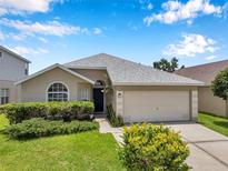 Charming single-story home with a well-manicured lawn and attached two-car garage at 899 Addison Ne Dr, St Petersburg, FL 33716