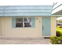 Charming home featuring a light-blue door, matching shutters, and well-maintained landscaping at 101 Cambridge Trl # 194, Sun City Center, FL 33573