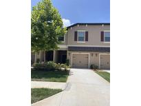 Townhome featuring two-car garage, neutral paint, and manicured landscaping at 11901 Castine St, New Port Richey, FL 34654