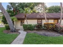 Charming single-story home featuring lush landscaping and a welcoming walkway at 1380 Azalea Dr # 1701, Dunedin, FL 34698