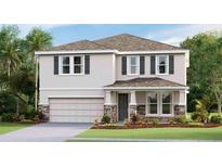 Two story home featuring gray siding with stone accents and black shutters at 2320 Stratten Dr, Zephyrhills, FL 33541