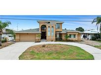 Stunning multi-story home features a manicured lawn and attached two-car garage at 333 Midway Is, Clearwater Beach, FL 33767