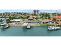 Stunning waterfront home featuring a private dock, boat lift, and inviting swimming pool for luxurious coastal living at 333 Midway Is, Clearwater Beach, FL 33767