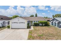Charming single-story home with a well-maintained lawn, attached garage, and inviting yellow front door at 6908 Mesa Verde St, Port Richey, FL 34668