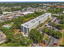 An aerial view of the residential building, parking lot, and green spaces at 701 S Madison Ave # 505, Clearwater, FL 33756