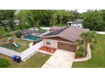 Charming single-Gathering home with a pool, playground, solar panels, and a well-maintained yard at 807 E Chapman Rd, Lutz, FL 33549