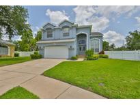 Charming two-story home featuring manicured lawn, two-car garage and beautifully arched entryway with decorative windows at 3633 Springville Dr, Valrico, FL 33596