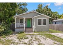 Charming single-story home with a green door and inviting front porch at 3953 10Th S Ave, St Petersburg, FL 33711