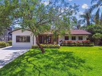 Charming single-story home with a lush front yard, mature tree, and well-maintained landscaping at 4522 S Hale Ave, Tampa, FL 33611