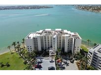 Beautiful waterfront condo building featuring manicured landscaping, private parking, and stunning views of the bay at 6105 Bahia Del Mar Cir # 682, St Petersburg, FL 33715