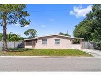 Charming single-story home featuring a quaint screened porch and classic Florida architecture under a clear blue sky at 7676 18Th St N, St Petersburg, FL 33702