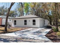 Charming single-story home featuring a well-manicured yard and a concrete driveway that adds curb appeal at 10219 Huntley St, New Port Richey, FL 34654