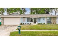 Charming single-story home featuring a well-maintained lawn and attached two-car garage at 206 Hillcrest Dr, Safety Harbor, FL 34695