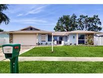 Charming single-story home featuring a well-manicured lawn, stone accents and a spacious two-car garage at 206 Hillcrest Dr, Safety Harbor, FL 34695