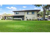 Inviting two-story condo featuring a well-manicured lawn and screened-in porch at 2941 Lichen Ln # B, Clearwater, FL 33760