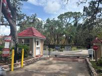 Gated community entrance with lush landscaping at Bermuda Bay Beach neighborhood, offering security and curb appeal at 3640 41St S Ln # F, St Petersburg, FL 33711