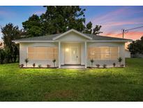 Charming single-story home featuring a well-manicured lawn, newly painted exterior, and inviting front porch at 4030 Moores Lake Rd, Dover, FL 33527