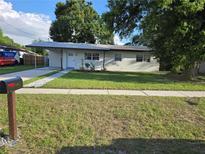 Charming single-story home with a well-maintained lawn and covered parking at 4104 W Wisconsin Ave, Tampa, FL 33616