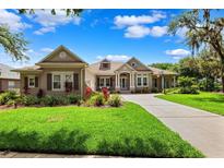 Charming single-story home with manicured lawn and mature trees against a beautiful blue sky at 5823 Terncrest Dr, Lithia, FL 33547