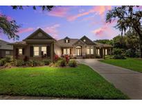 Charming single-story home with a well-manicured lawn, mature landscaping, and inviting curb appeal at 5823 Terncrest Dr, Lithia, FL 33547
