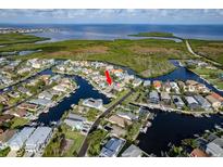 Stunning aerial view of waterfront homes with docks and boats in a beautiful coastal community at 6340 Garland Ct, New Port Richey, FL 34652