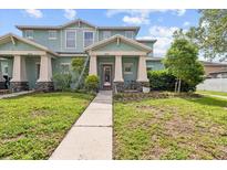Charming two-story townhome with a well-manicured lawn and inviting entrance at 6934 Duffy Ln, Tampa, FL 33616