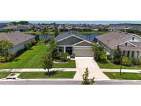 Charming single-Gathering home featuring a well-manicured lawn and landscaping with a two car garage at 7116 Estero Ct, Apollo Beach, FL 33572