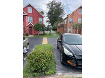 Charming townhome featuring colorful exterior, neat landscaping, and convenient parking at 10436 White Lake Ct # 10436, Tampa, FL 33626