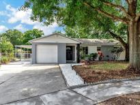 Charming single-story home features a well-maintained lawn, attached garage, and cozy front porch at 1135 17Th Sw Ave, Largo, FL 33778