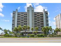 High-rise building featuring a clean facade, palm trees, and meticulously maintained landscaping, adding to the property's allure at 1290 Gulf Blvd # 702, Clearwater Beach, FL 33767
