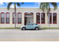 Charming Box Factory Lofts building featuring a light-colored exterior and attractive red-framed windows at 2001 E 2Nd Ave # 37, Tampa, FL 33605