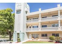 Aloha building exterior shows white siding, balconies, and decorative architectural details at 2330 Ecuadorian Way # 30, Clearwater, FL 33763