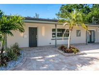Stylish home exterior displaying modern lighting, fresh landscaping, and a gray front door at 243 45Th Ne Ave, St Petersburg, FL 33703