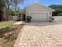 Charming single-story home with a brick driveway and a well-maintained front yard at 2950 N North Oriente Avenue N Ave, Sarasota, FL 34235