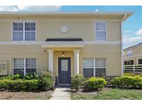 Inviting two-story home with a covered entryway, lush landscaping, and a charming architectural design at 3406 Dragon View Ct, Valrico, FL 33594