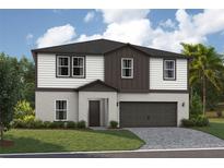 Charming two-story home with a well-manicured lawn and attached two-car garage at 36927 Sagemoor Dr, Zephyrhills, FL 33541