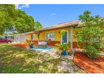 Charming home with a cozy front porch, colorful landscaping, and a welcoming entrance at 5236 Madison St, New Port Richey, FL 34652