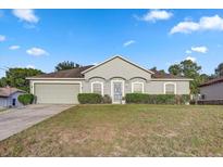 Charming single-story home with a well-maintained lawn and an attached two-car garage at 5396 Berrien Ave, Spring Hill, FL 34608