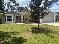 Charming single-story home with a well-maintained lawn and mature trees at 8033 55Th E St, Palmetto, FL 34221