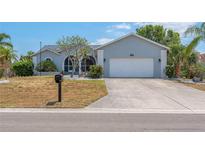 Charming single-story home with a two-car garage, manicured landscaping, and a well-maintained lawn at 832 Birdie Way, Apollo Beach, FL 33572