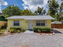 Charming yellow single-story home featuring a well-maintained yard and inviting front entrance at 932 W Wheeler Rd, Brandon, FL 33510