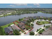 Aerial view of a lovely home with lake view and community pool area at 10081 Sage Creek Dr, Sun City Center, FL 33573