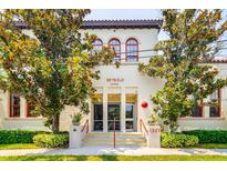 Seybold Lofts exterior showing red window frames, terra cotta roof trim, and address number over manicured garden at 1501 W Horatio St # 101, Tampa, FL 33606